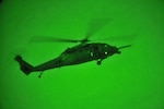 A U.S. Air Force HH-60G Pave Hawk helicopter from the 101st Rescue Squadron conducts a nighttime live fire exercise at Warren Grove Gunnery Range in Ocean County, N.J., Aug. 29, 2013. Alaska Airmen used night vision gear and a similar helicopter to rescue four hypothermic people from a lake.