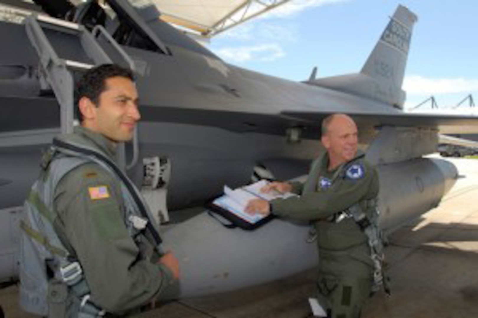 Capt. Fassi Fehri, left, a pilot with the Moroccan air force, receives an F-16 orientation flight, from Air Force Lt. Col. Scott Lambe, commander of the 169th Operations Support Flight at McEntire Joint National Guard Base, S.C. Fehri is to become Morocco's first F-16 fighter pilot. Through the State Partnership program with the Utah Air National Guard, the 169th Fighter Wing from the South Carolina Air National Guard has agreed to assist the Moroccan air force with their transition to F-16 fighter operations.