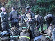 Marines and sailors with 2nd Medical Battalion, Combat Logistics Regiment 25, 2nd Marine Logistics Group unload nonperishable items at the halfway point of a six mile hike aboard Camp Lejeune, N.C., Nov. 15, 2013. Service members with the battalion were encouraged to pack goods to be donated to families in need for the holidays.  (U.S. Marine Corps photo by Lance Cpl. Shawn Valosin)