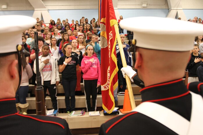 Marines with the 9th Marine Corps District, present the colors for students at Oxford Middle School in Overland Park, KS Nov. 15. The students and faculty hosted a Veteran's Day celebration honoring the faithful and dedicated service of military members worldwide. (Photo by Lance Cpl. Bradley D. Carrier)