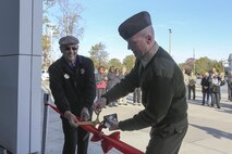 NORFOLK, Va. (Nov. 15, 2013) – Col. Paul Ryan, commanding officer, Headquarters and Service Battalion, U.S. Marine Corps Forces Command, and Ken Boyer, business operations director for Marine Corps Community Services, re-open the new Elmore Marine Corps Exchange during a ribbon cutting ceremony Nov. 15. On the day of the re-open, the exchange gave away prizes and hosted Hampton Roads area Montford Point Marines, who spoke with and signed autographs for Marines and Sailors. The exchange re-opened after undergoing months of renovations.
