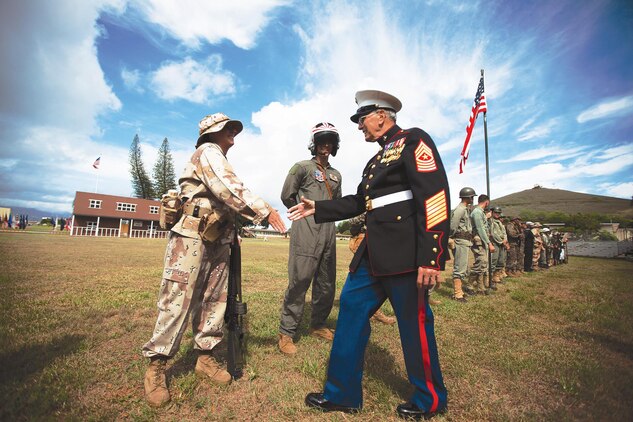 Retired Sgt. Maj. James Snyder, an 82-year-old veteran of the Korean War and Vietnam, who served for 28 years, and a native of Dayton, Ohio, shakes hands with Marines dressed in uniforms from periods throughout Marine Corps history during the 2013 Marine Corps Base Hawaii birthday pageant at Dewey Square, Nov. 8, 2013. Each costume is a replica of a uniform worn during different historical eras, from the Revolutionary War high collar, or “Leatherneck,” to the current camouflage utilities. Each uniform highlights the evolution of the Marine Corps from past to present, while also showing Marines still carry the same values and traditions today as when the Corps was established in 1775. (U.S. Marine Corps photo by Lance Cpl. Matthew Bragg)