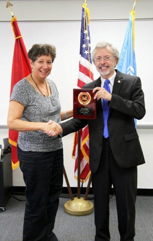 Merry Henley (left) receives the IWR Employee of the Year award from IWR Director Robert Pietrowsky (right).