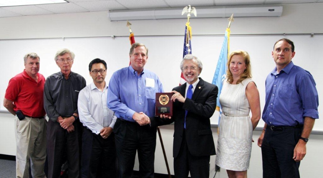 The U.S. Port and Inland Waterways Modernization Study Team receives the Team of the Year award from IWR Director Robert Pietrowsky (center). Team leader Keith Hofseth accepts the award for the team. Left to Right: Henri Langlois, Richard Cole, Jae Chung, Keith Hofseth, Robert Pietrowsky, Kelly Barnes, Hal Cardwell.