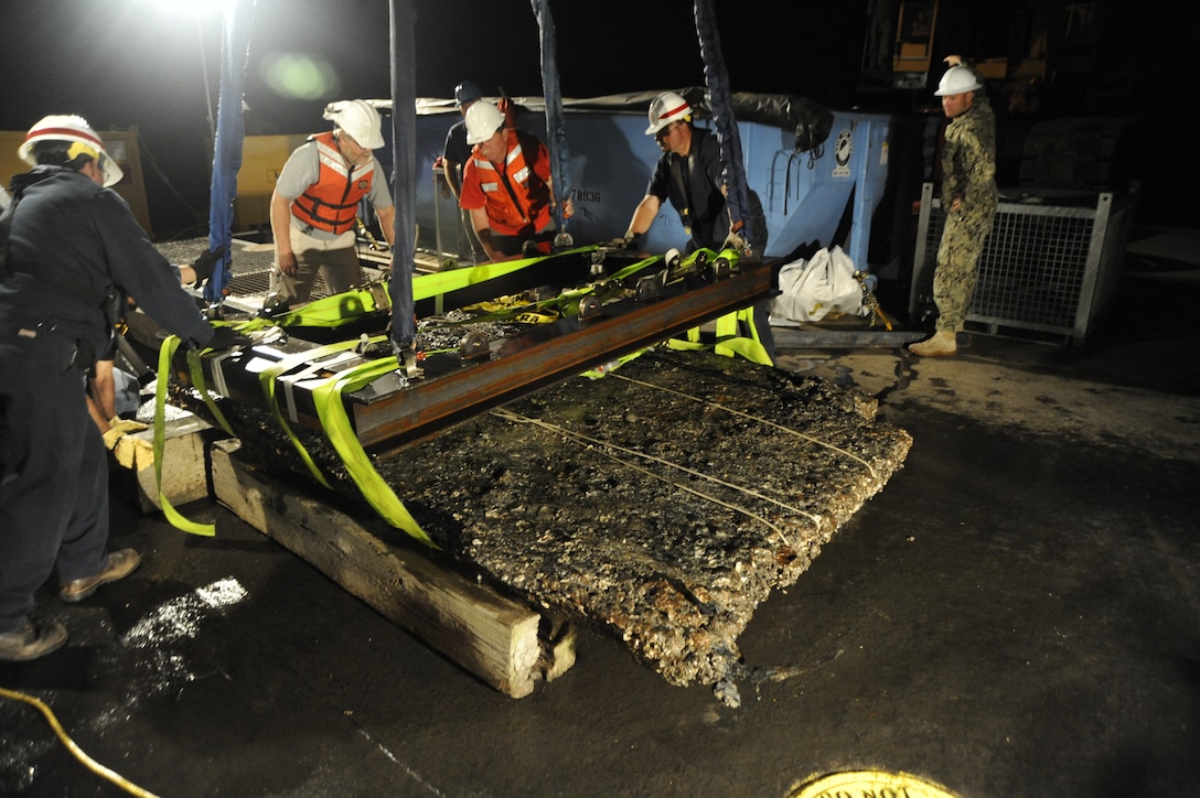 Archeologists working for the U.S. Army Corps of Engineers, Savannah District, and divers and salvage operations teams from the U.S. Navy, retrieve a 64-square foot section of a Civil War ironclad warship from the bottom of the Savannah River the evening of Nov. 12, 2013. U.S. Navy photo.