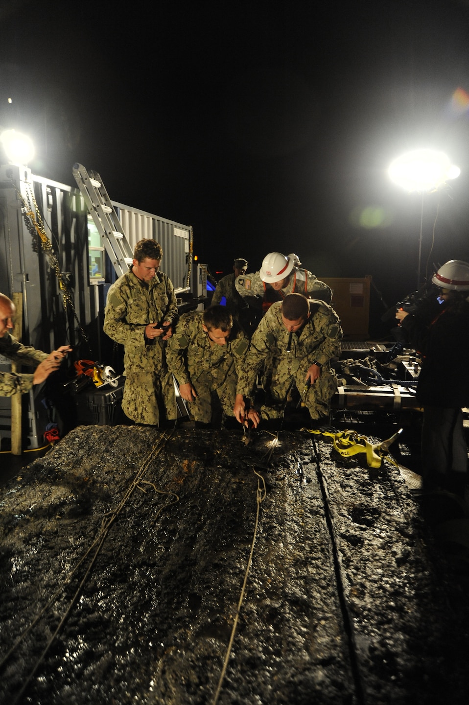 Archeologists working for the U.S. Army Corps of Engineers, Savannah District, and divers and salvage operations teams from the U.S. Navy, retrieve a 64-square foot section of a Civil War ironclad warship from the bottom of the Savannah River the evening of Nov. 12, 2013. U.S. Navy photo.