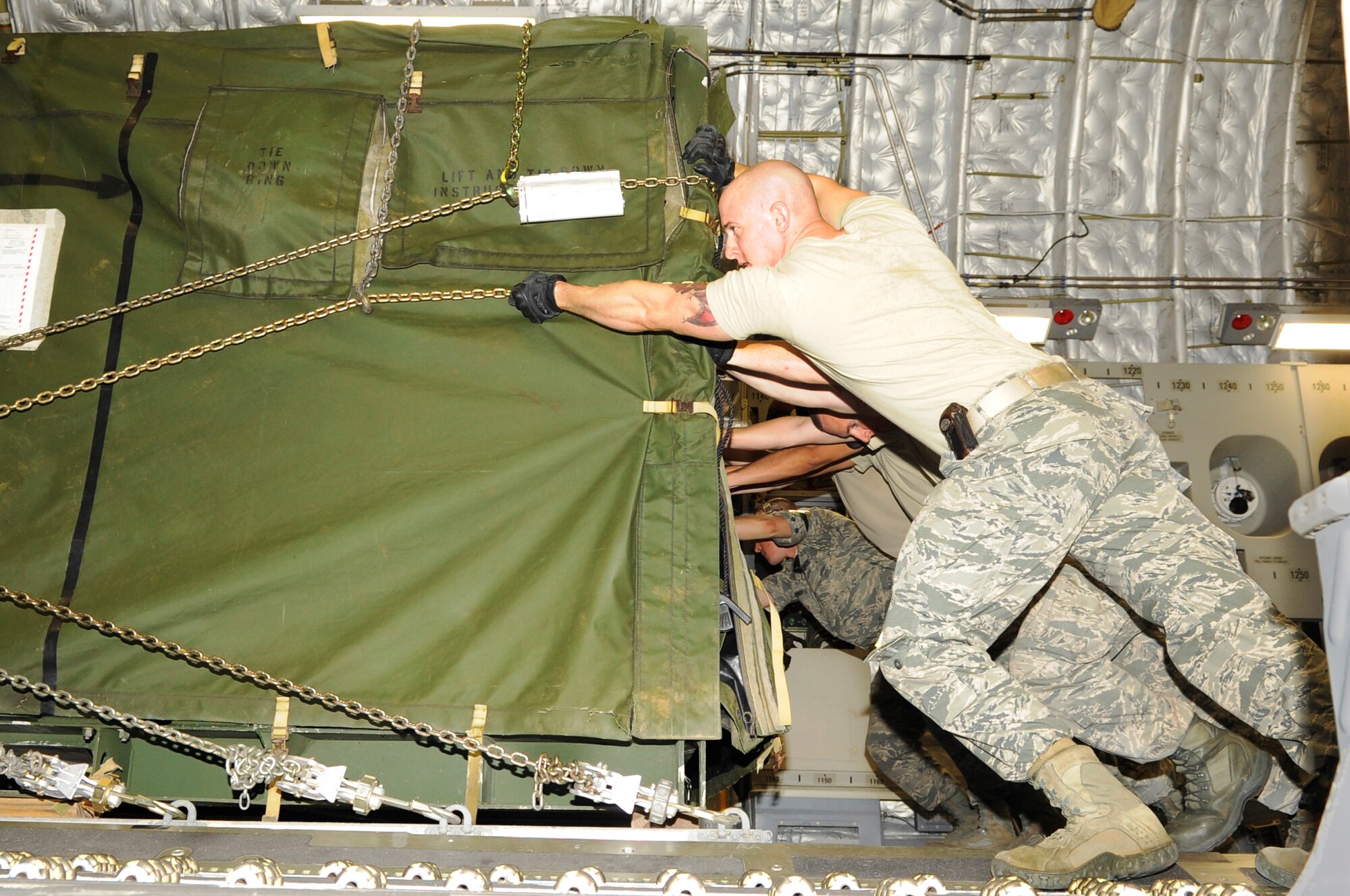 Airmen from the 733rd Air Mobility Squadron load supplies onto a C- 17 Globemaster III from Joint Base Pearl Harbor-Hickam, Hawaii, on Kadena Air Base, Japan, Nov. 15, 2013. More than 50 Marines along with members of the Air Force, Army and Navy will be heading to the Philippines to assist the locals recover from Super Typhoon Haiyan. (U.S. Air Force photo by Senior Airman Marcus Morris) 