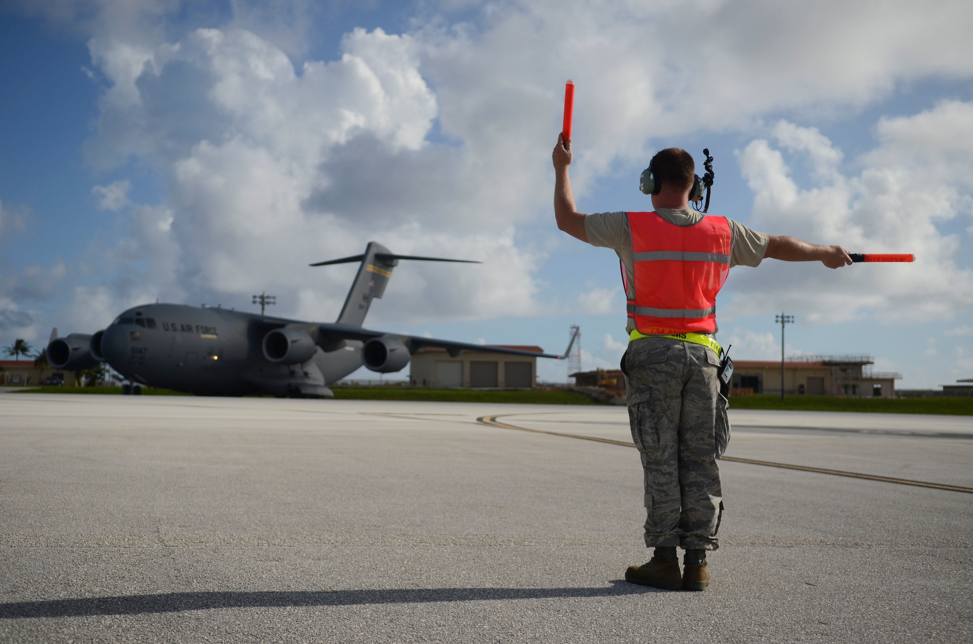 Staff Sgt. Richard Lehman, 734th Air Mobility Squadron avionics specialist, marshalls a C-17 Globemaster III to the taxiway Nov. 15, 2013, on the Andersen Air Force Base, Guam, flightline before the aircraft departs to support Operation Damayan in Tacloban, Philippines. Operation Damayan is a U.S. humanitarian aid and disaster relief effort to support the Philippines in the wake of the devastating effects of Typhoon Haiyan. (U.S. Air Force photo by Senior Airman Marianique Santos/Released)