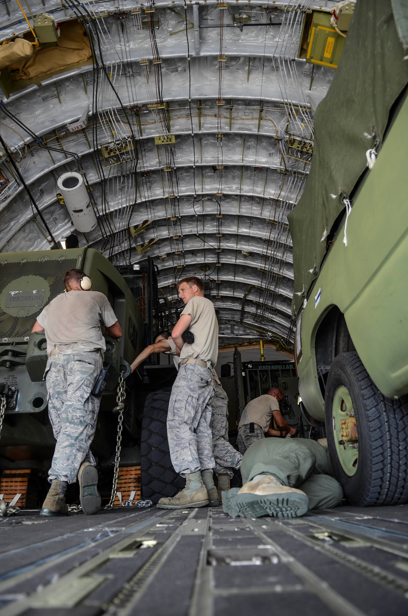 Airmen from the 36th Contingency Response Group secure vehicles into a C-17 Globemaster III Nov. 15, 2013, on the Andersen Air Force Base, Guam, flightline before departing to support Operation Damayan in Tacloban, Philippines. Operation Damayan is a U.S. humanitarian aid and disaster relief effort to support the Philippines in the wake of the devastating effects of Typhoon Haiyan. (U.S. Air Force photo by Senior Airman Marianique Santos/Released)