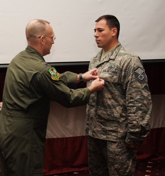 Master Sgt. Donald Treglia, 11th Bomb Squadron superintendent, receives the Bronze Star medal from Col. Michael Adderley, 2nd Operations Group commander, during a Commander's Call on Barksdale Air Force Base, La., Nov. 8, 2013. The Bronze Star is awarded to a service member who has distinguished himself by heroic or meritorious achievement or service, not involving participation in aerial flight, in connection with military operations against an armed enemy.