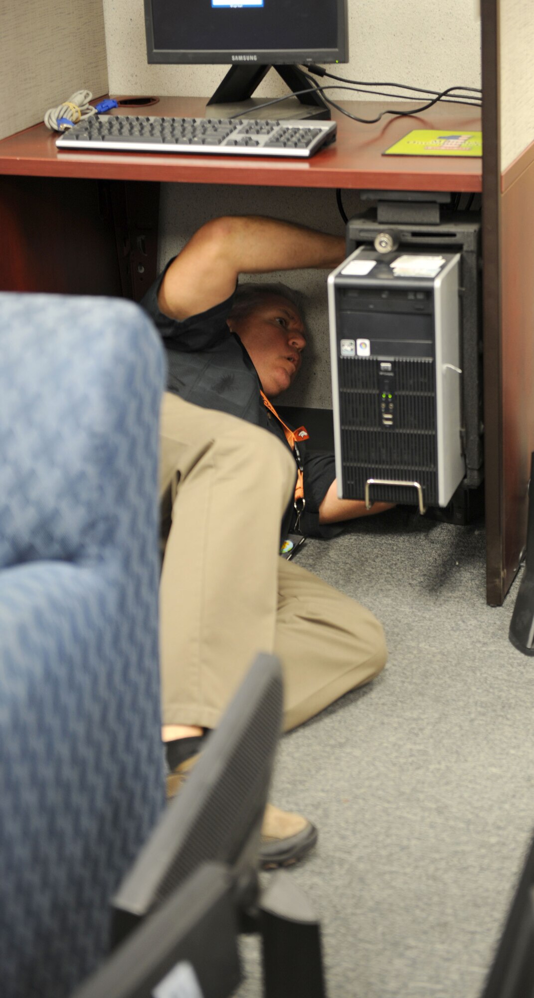 Bryan Hopper, Airman and Family Readiness Center community readiness specialist, plugs in one of more than 20 new monitors the A&FRC received through the General Services Administration Federal Acquisition Service. The monitors were excess equipment and were matched with the A&FRC through GSA, a company that assists government agencies with the procurement of items such as office supplies, computer products, security and furniture. (U.S. Air Force photo by Airman 1st Class Saphfire Cook/Released) (cropped)