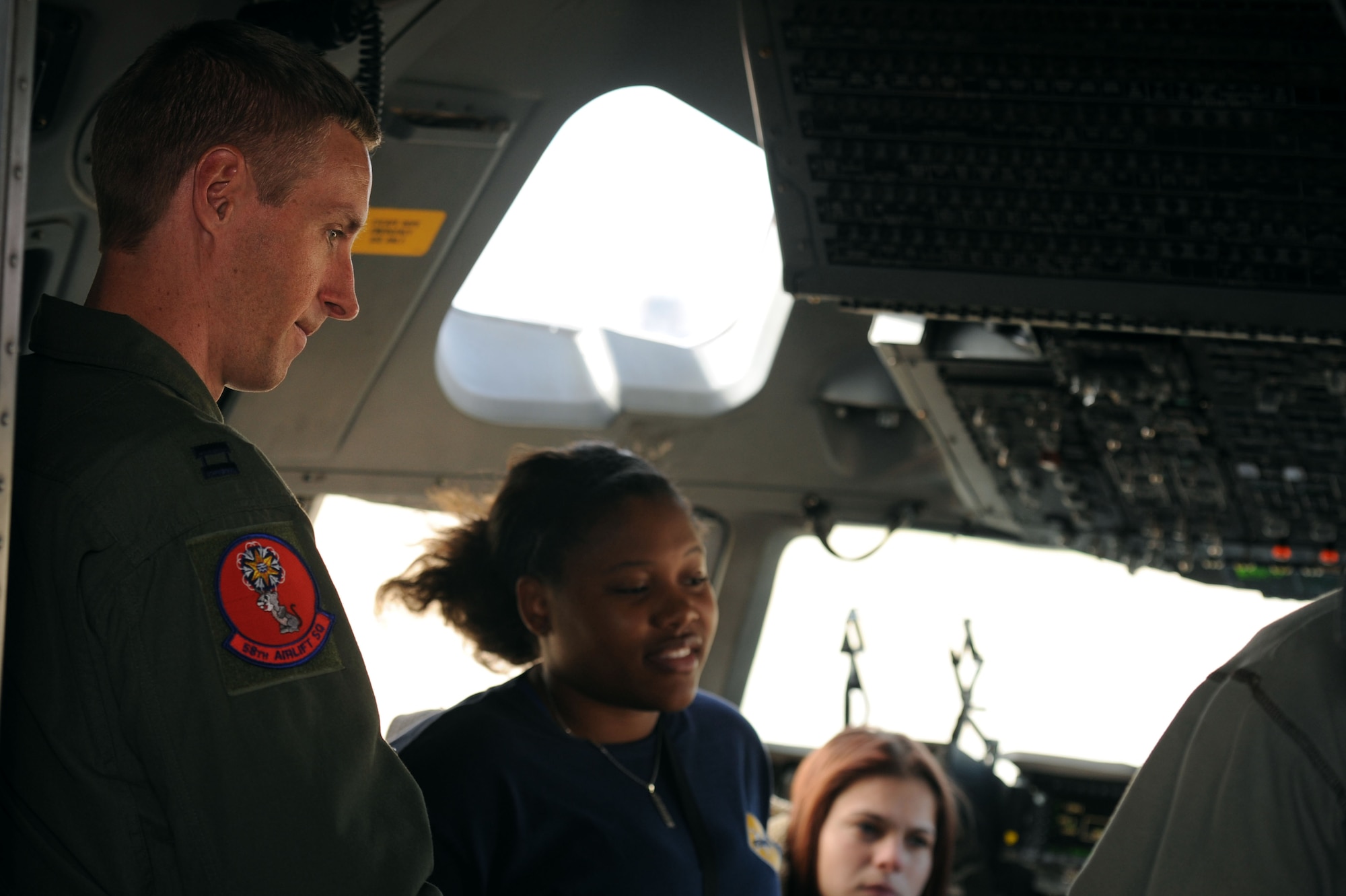 ALTUS AIR FORCE BASE, Okla. – U.S. Air Force Capt. Andreas Johnsen, 58th Airlift Squadron C-17 Globemaster III pilot, shares his expertise as a pilot with Junior Reserve Officers’ Training Corps high school students from Lawton, Okla. inside the cockpit of an Air Force C-17 cargo aircraft on the flight line Nov. 14, 2013. About 30 JROTC students from three different high schools in Lawton visited the base to learn about the Air Force mission and different Air Force specialty codes. (U.S. Air Force photo by Airman 1st Class Klynne Pearl Serrano/Released)