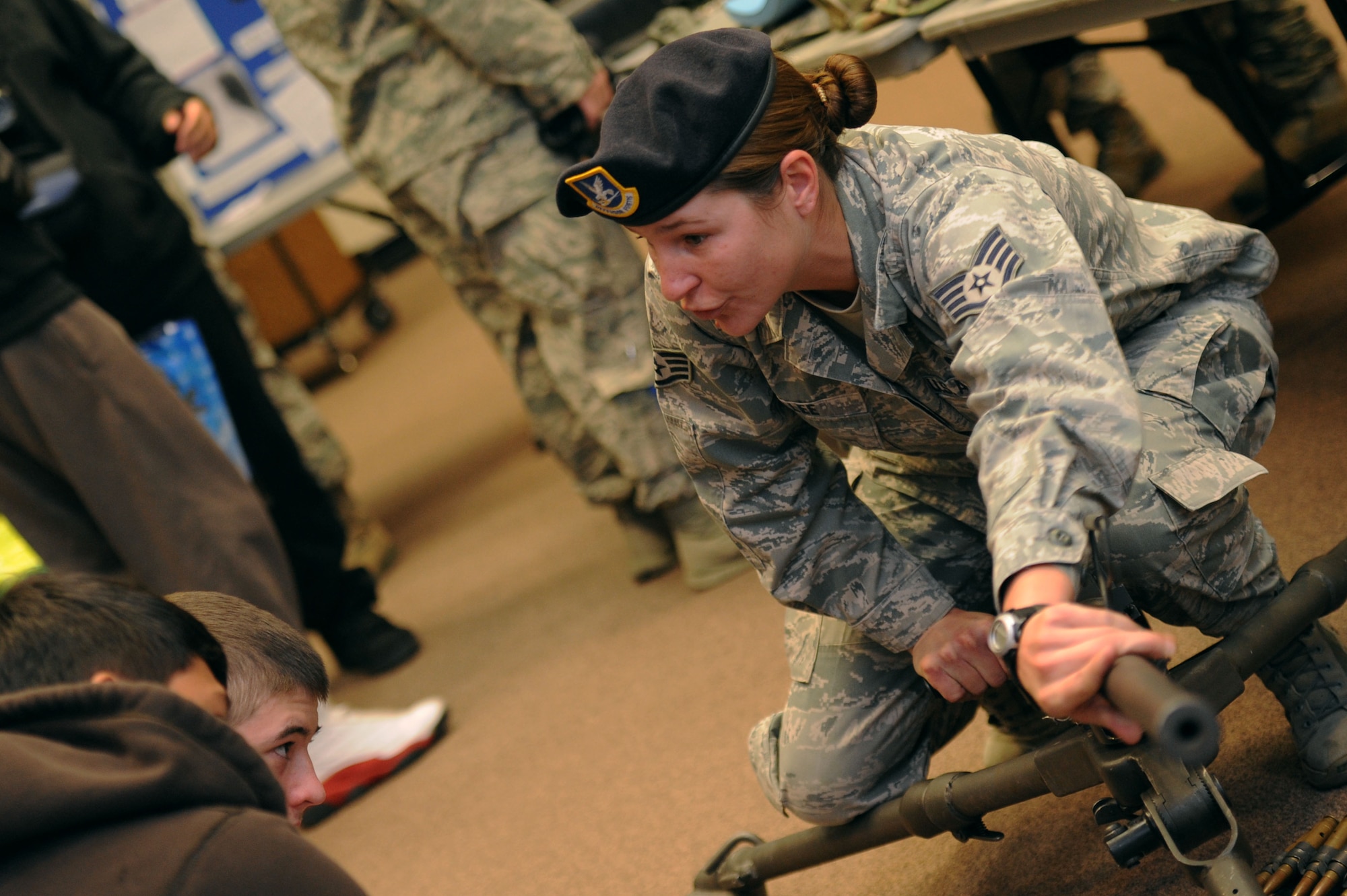ALTUS AIR FORCE BASE, Okla. – U.S. Air Force Staff Sgt. Angelena Lee, 97th Security Forces Squadron combat arms instructor, shows Junior Reserve Officers’ Training Corps high school students from Lawton, Okla. the different parts of a M-2 Browning machine gun during a career fair held at the Freedom Community Center Nov. 14, 2013. About 30 JROTC students from three different high schools in Lawton, Okla. visited the base to learn about the Air Force mission and different Air Force specialty codes. (U.S. Air Force photo by Airman 1st Class Klynne Pearl Serrano/Released)