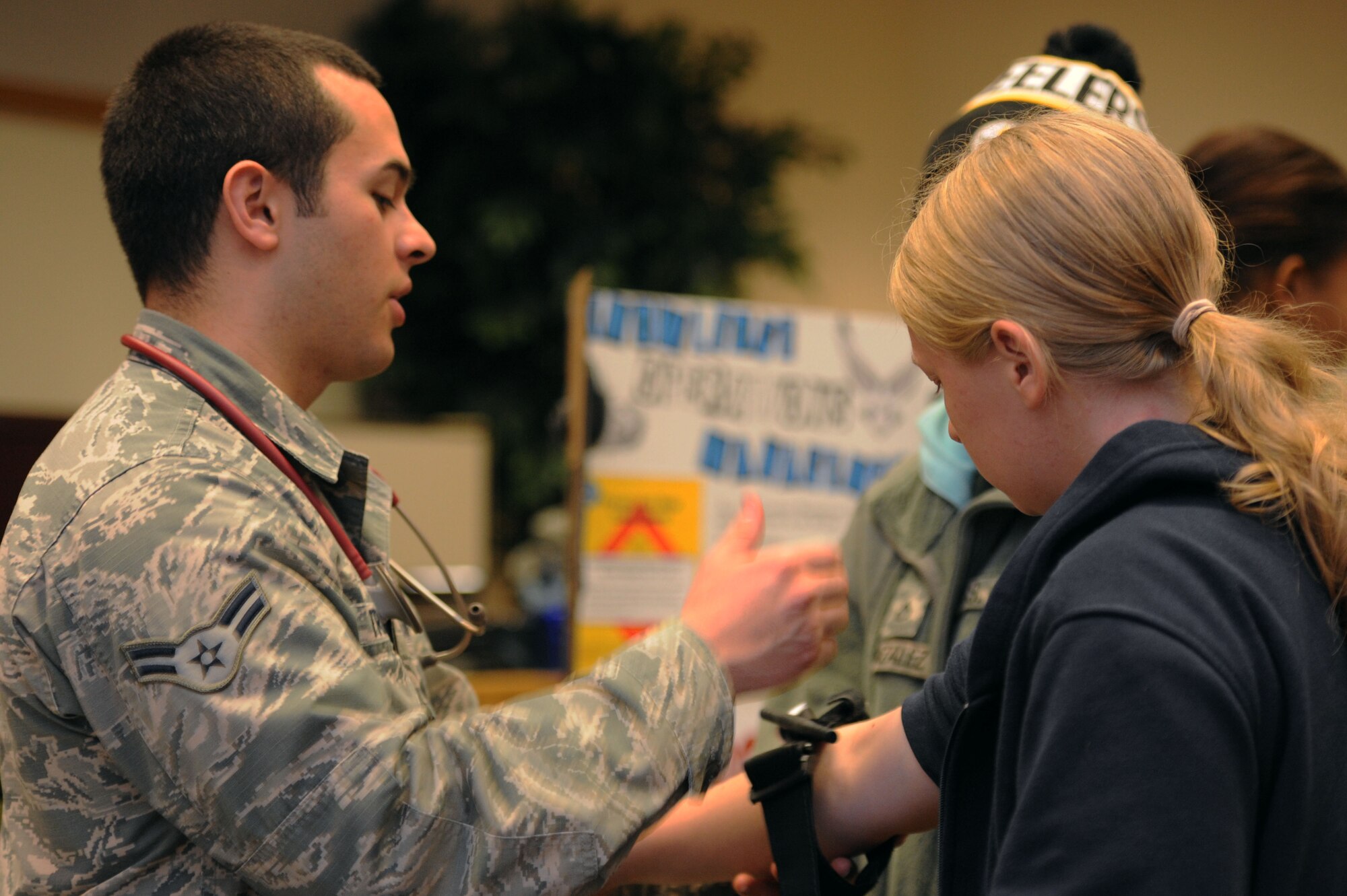 ALTUS AIR FORCE BASE, Okla. – U.S. Air Force Airman 1st Class Michael Triana, 97th Medical Group aerospace medical technician, demonstrates how to use a tourniquet to Junior Reserve Officers’ Training Corps high school students from Lawton, Okla. during a career fair held at the Freedom Community Center Nov. 14, 2013. Triana, along with Airmen from various units on base, set up information booths and shared their expertise and knowledge of their jobs with the students. The career fair was held to highlight the Air Force mission and different Air Force specialty codes. (U.S. Air Force photo by Airman 1st Class Klynne Pearl Serrano/Released)