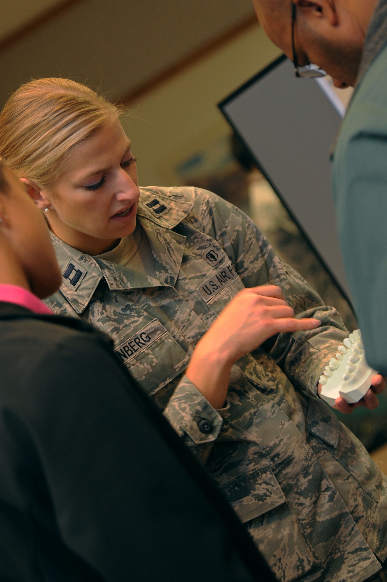 ALTUS AIR FORCE BASE, Okla. – U.S. Air Force Capt. Jessica Isenberg, 97th Medical Operations Squadron dentist, shows Junior Reserve Officers’ Training Corps high school students from Lawton, Okla. a dental model during a career fair held at the Freedom Community Center Nov. 14, 2013. The career fair highlighted the Air Force mission and different Air Force specialty codes.  (U.S. Air Force photo by Airman 1st Class Klynne Pearl Serrano/Released)