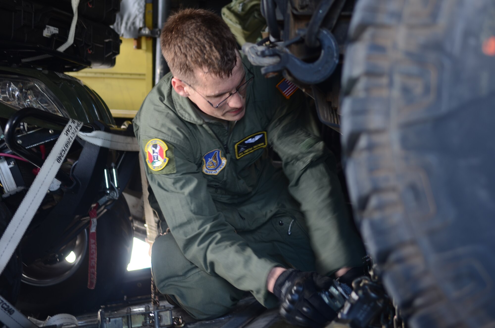 Senior Airman Timothy Oberman, 36th Airlift Squadron C-130 Hercules loadmaster, secures a HUMVEE inside the aircraft Nov. 14, 2013, on the Andersen Air Force Base, Guam, flightline, before departing to support Operation Damayan in Tacloban, Philippines. Operation Damayan is a U.S. humanitarian aid and disaster relief effort to support the Philippines in the wake of the devastating effects of Typhoon Haiyan. (U.S. Air Force photo by Senior Airman Marianique Santos/Released)
