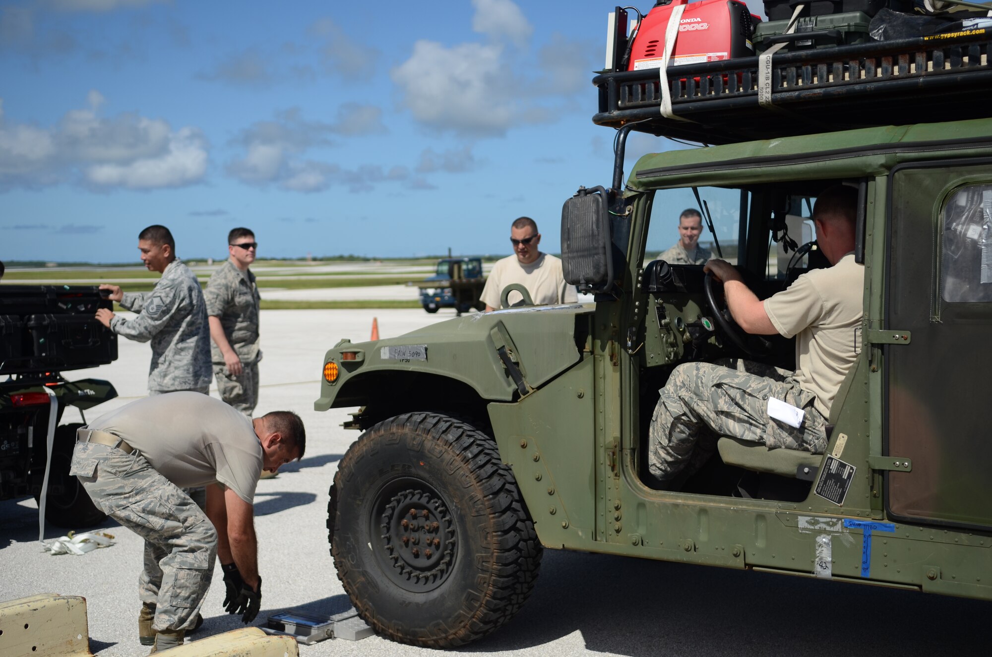 Airmen from the 734th Air Mobility Squadron and 36th Contingency Response Group weigh vehicles and equipment bound for the Philippines Nov. 14, 2013, on the Andersen Air Force Base, Guam, flightline, in support of Operation Damayan. Operation Damayan is a U.S. humanitarian aid and disaster relief effort to support the Philippines in the wake of the devastating effects of Typhoon Haiyan. (U.S. Air Force photo by Senior Airman Marianique Santos/Released)