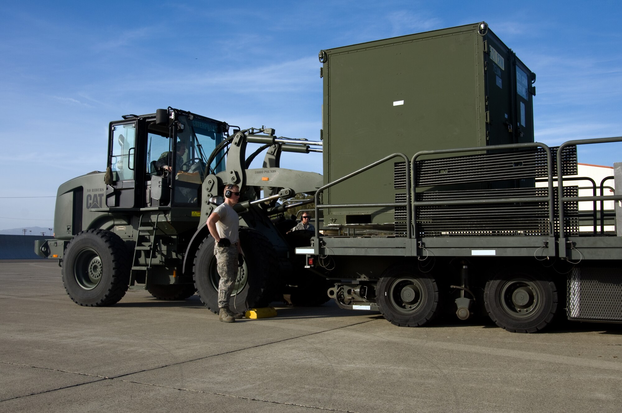 U.S. Air Force Airmen from the 621st Contingency Response Wing, load a cargo box onto a K-loader during a Golden Bear exercise Nov. 6, 2013, at Travis Air Force Base, Calif. (U.S. Air Force photo/Senior Airman Charles Rivezzo)