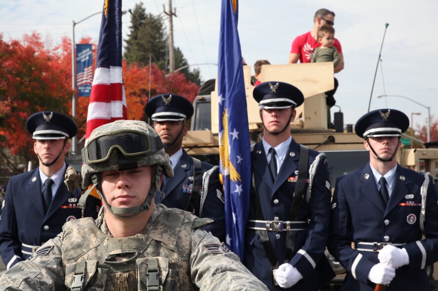 Senior Airman Adam Biernacki, a 940th Security Forces Squadron reservist from Beale Air Force Base, Calif., mounts an All Terrain Vehicle ahead of the Honor Guard flag detail from Travis Air Force Base, Calif., at the Elk Grove Veterans Day Parade, Nov. 11.  The annual event was reportedly the largest Veterans Day parade in the area.  (U.S. Air Force photo by Tech. Sgt. Kenneth McCann)