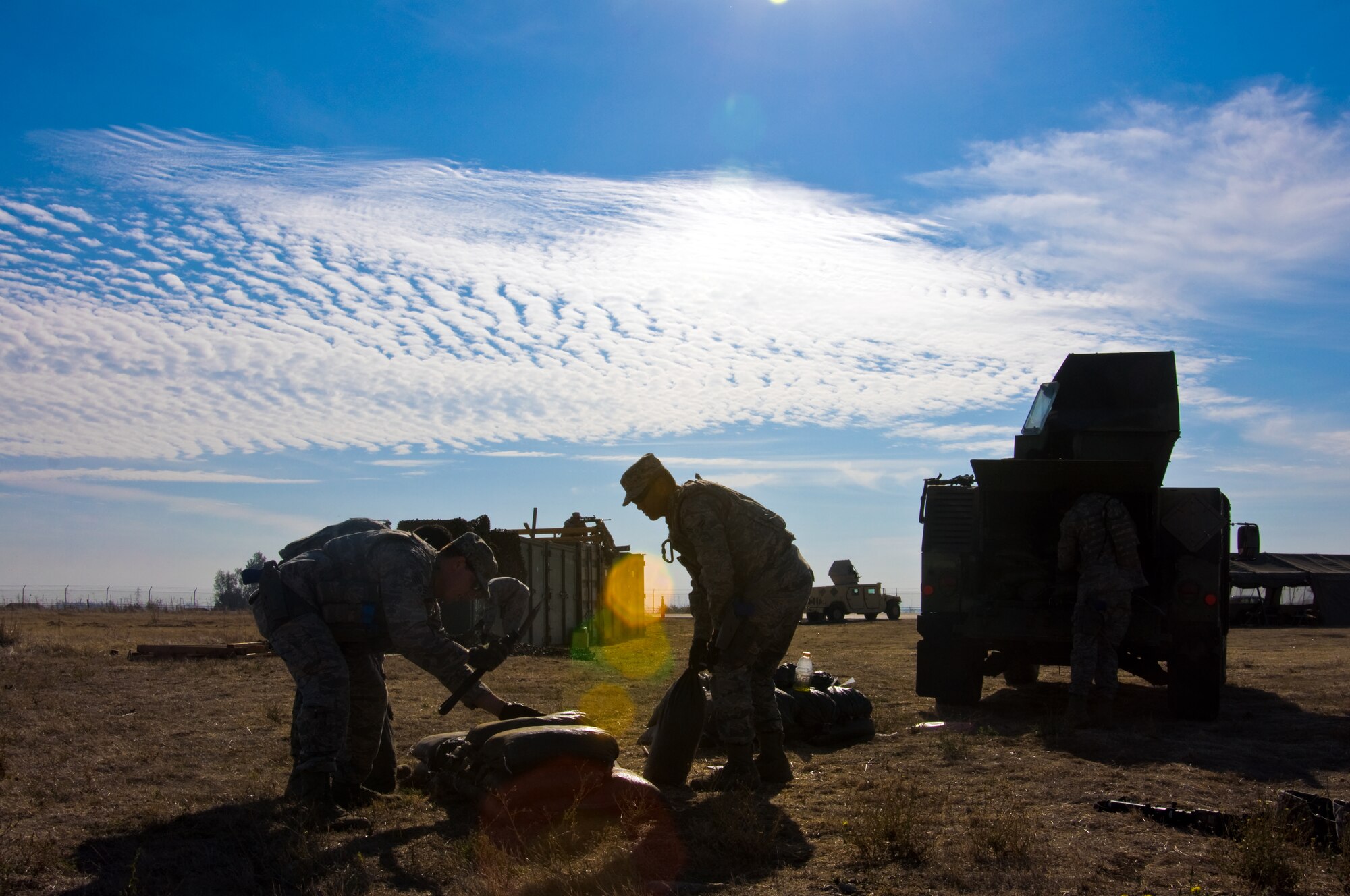 U.S. Air Force Airmen from the 570th Global Mobility Readiness Squadron prepare a defensive fighting position at a mock forward operating base during a Golden Bear exercise Nov. 6, 2013, at Travis Air Force Base, Calif.  (U.S. Air Force photo/Senior Airman Charles Rivezzo)