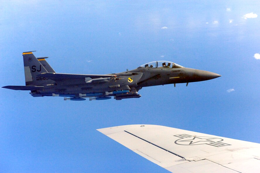 An F-15E Strike Eagle assigned to Seymour Johnson Air Force Base, N.C., flies alongside a KC-135R Stratotanker during Exercise RAZOR TALON, Nov. 15, 2013.  The KC-135Rs provide a key role in the exercise, refueling fighter jets midflight to keep them in the action longer.  (U.S. Air Force photo by Airman 1st Class Brittain Crolley)