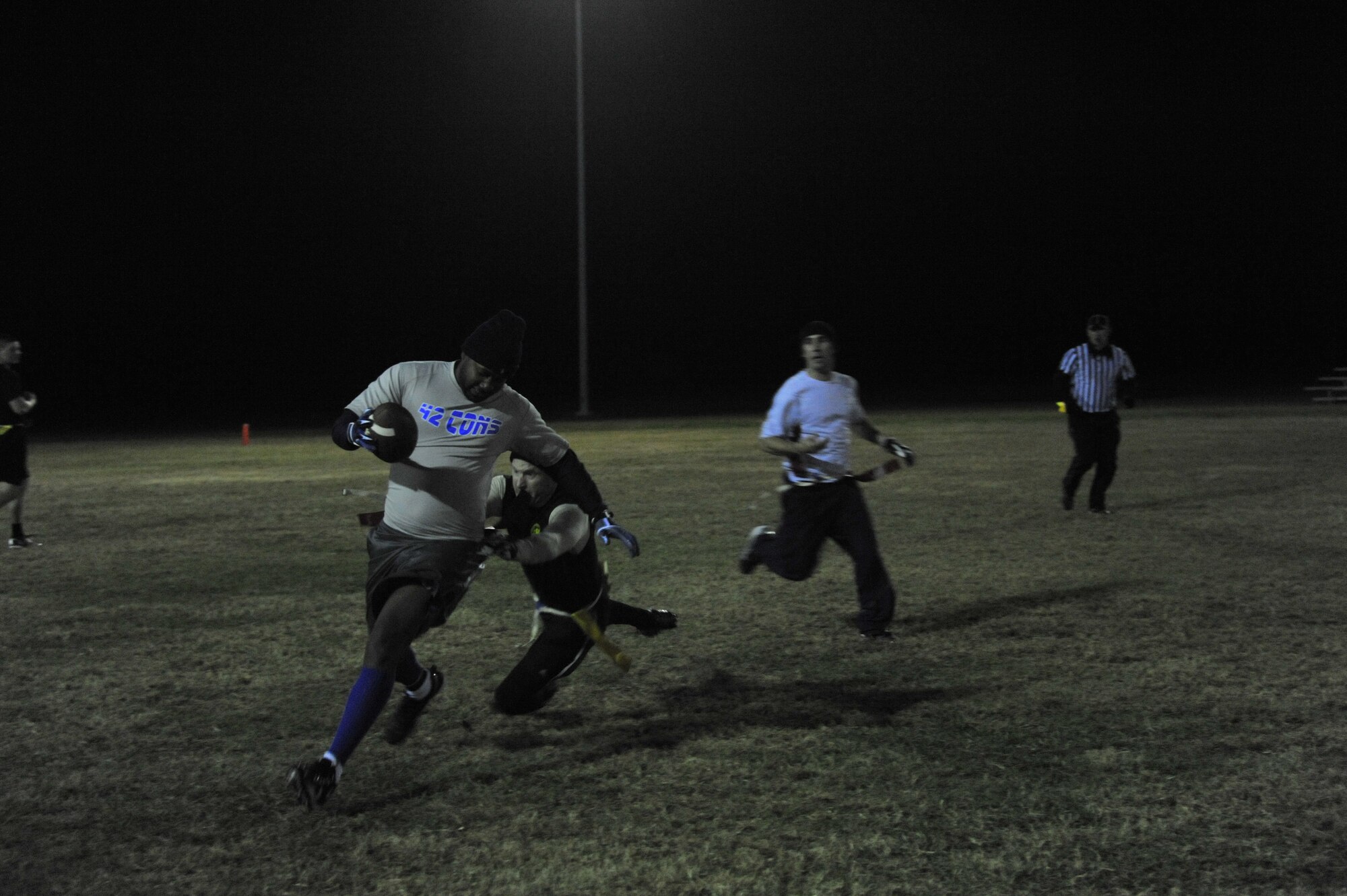 Austin Parker, 42nd CONS receiver, runs the ball down the field during a football game against HQAU Nov. 13, 2013. Parker contributed two touchdowns to his team’s 27-0 win. (U.S. Air Force photo by Staff Sgt. Natasha Stannard)