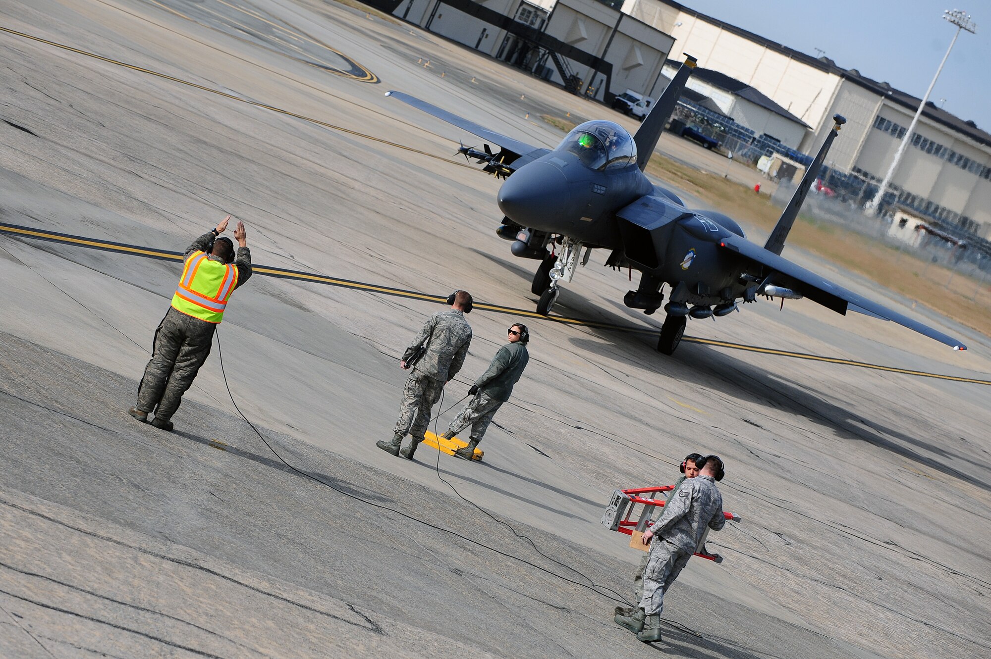 A U.S. Air Force Airmen assigned to the 4th Fighter Wing marshals in an F-15E Strike Eagle aircraft for a pre-flight inspection during Exercise RAZOR TALON at Seymour Johnson Air Force Base, N.C., Nov. 15, 2013. RAZOR TALON is a monthly, large force exercise and joint-service training opportunity to employ cutting edge operational tactics. (U.S. Air Force photo by Airman 1st Class John Nieves Camacho)