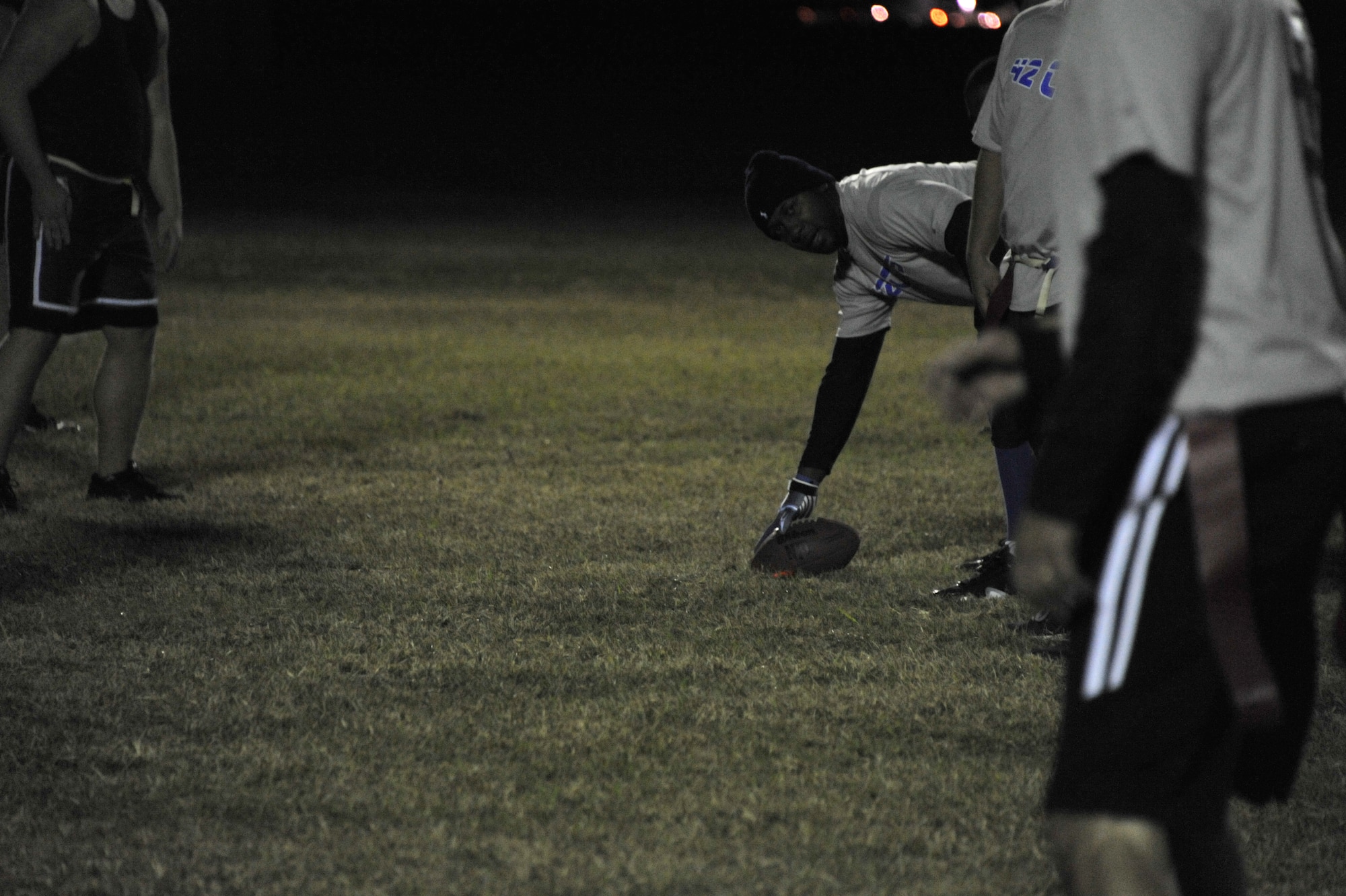 Austin Parker, 42nd CONS receiver, prepares to hike the ball during CONS’ match against HQAU Nov. 13, 2013. CONS defeated HQAU team 27-0. Both teams will play in the play-off Nov. 14-21. (U.S. Air Force photo by Staff Sgt. Natasha Stannard) 