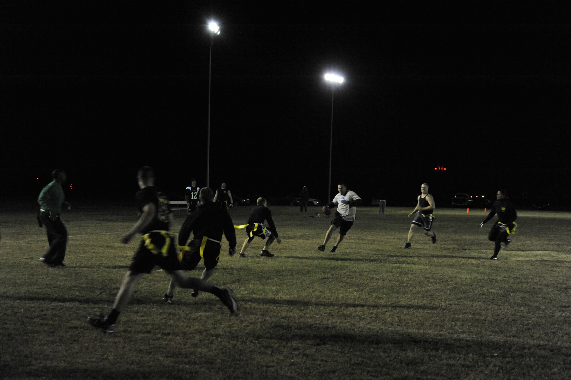 Patrick Cady, 42nd CONS quarterback, scrambles for a 17-yard touchdown during a match against HQAU Nov. 13, 2013. The CONS team now holds a 4-2 record and is set to play in base play-offs Nov. 14-21. (U.S. Air Force photo by Staff Sgt. Natasha Stannard)