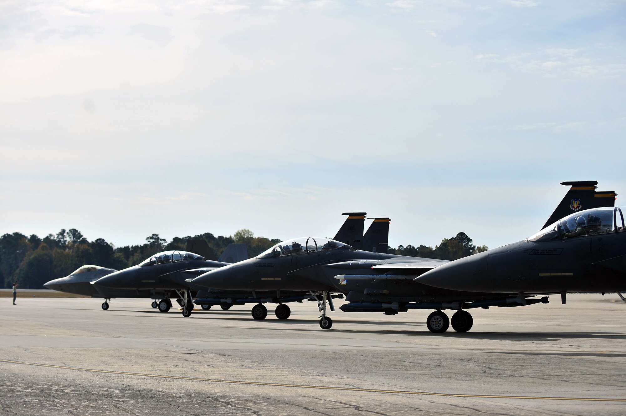 Multiple F-15E Strike Eagle and F-22 Raptor aircraft prepare for take-off at Seymour Johnson Air Force Base, N.C, during Exercise RAZOR TALON, Nov. 15, 2013. RAZOR TALON is a monthly, large force exercise and joint-unit training opportunity to employ cutting edge operational concepts on the Atlantic Coast. (U.S. Air Force photo by Tech. Sgt. Brittany E. Jones)