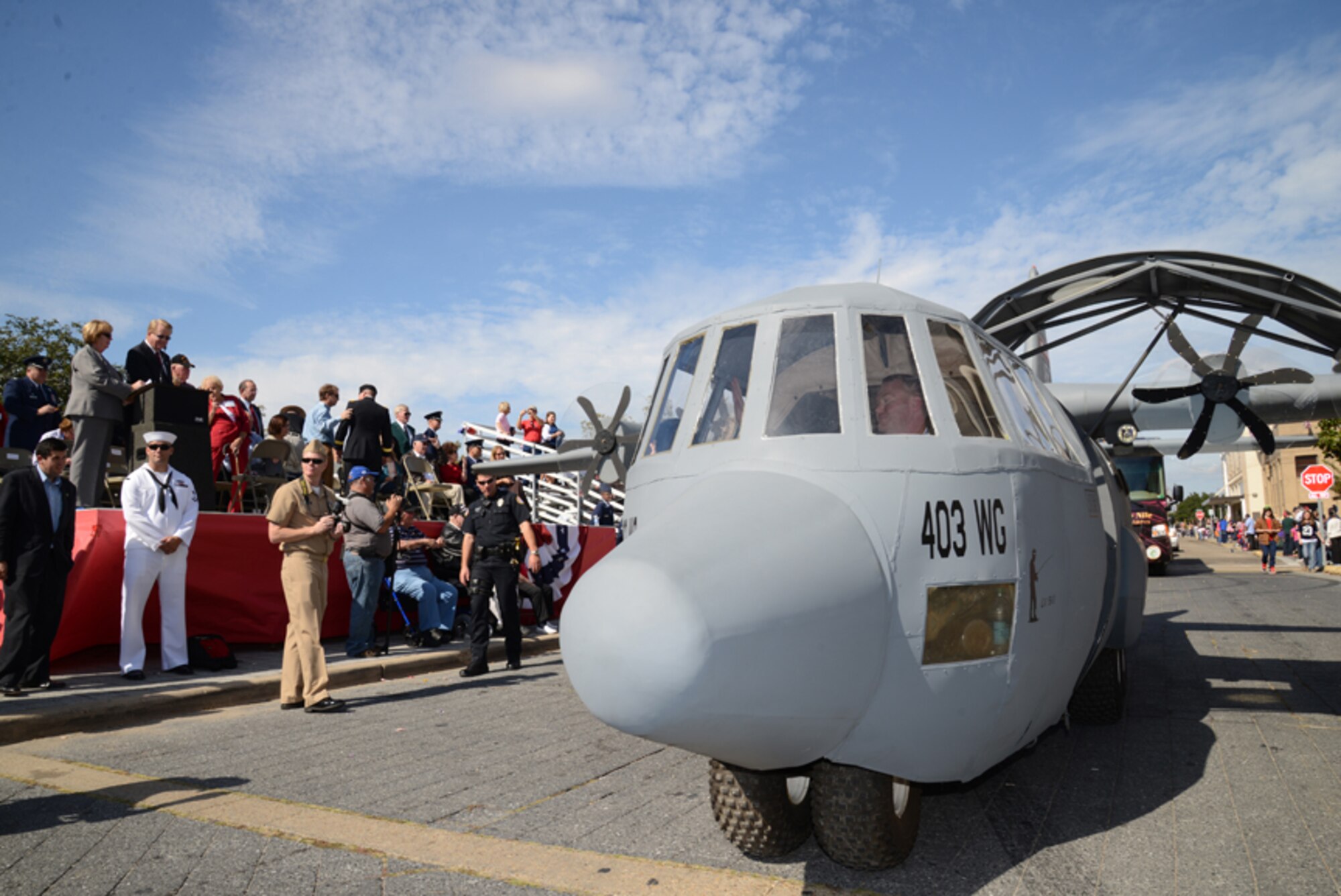 Master Sgt. Brian Lamar, 403rd Wing Public Affairs noncommissioned officer in charge, pilots Lil' Bill past the reviewing stands in front of city hall during the Biloxi Veterans Day parade Nov. 9. Members of the 403rd Wing, Keesler Air Force Base, Miss., guided the mock C-130J aircraft down the streets of Biloxi, Miss., during the event. Hundreds of people turned out to view the procession of floats, bands and marching units to show their appreciation for members of the U.S. Armed Forces. (U.S. Air Force photo/Tech. Sgt. Ryan Labadens)
