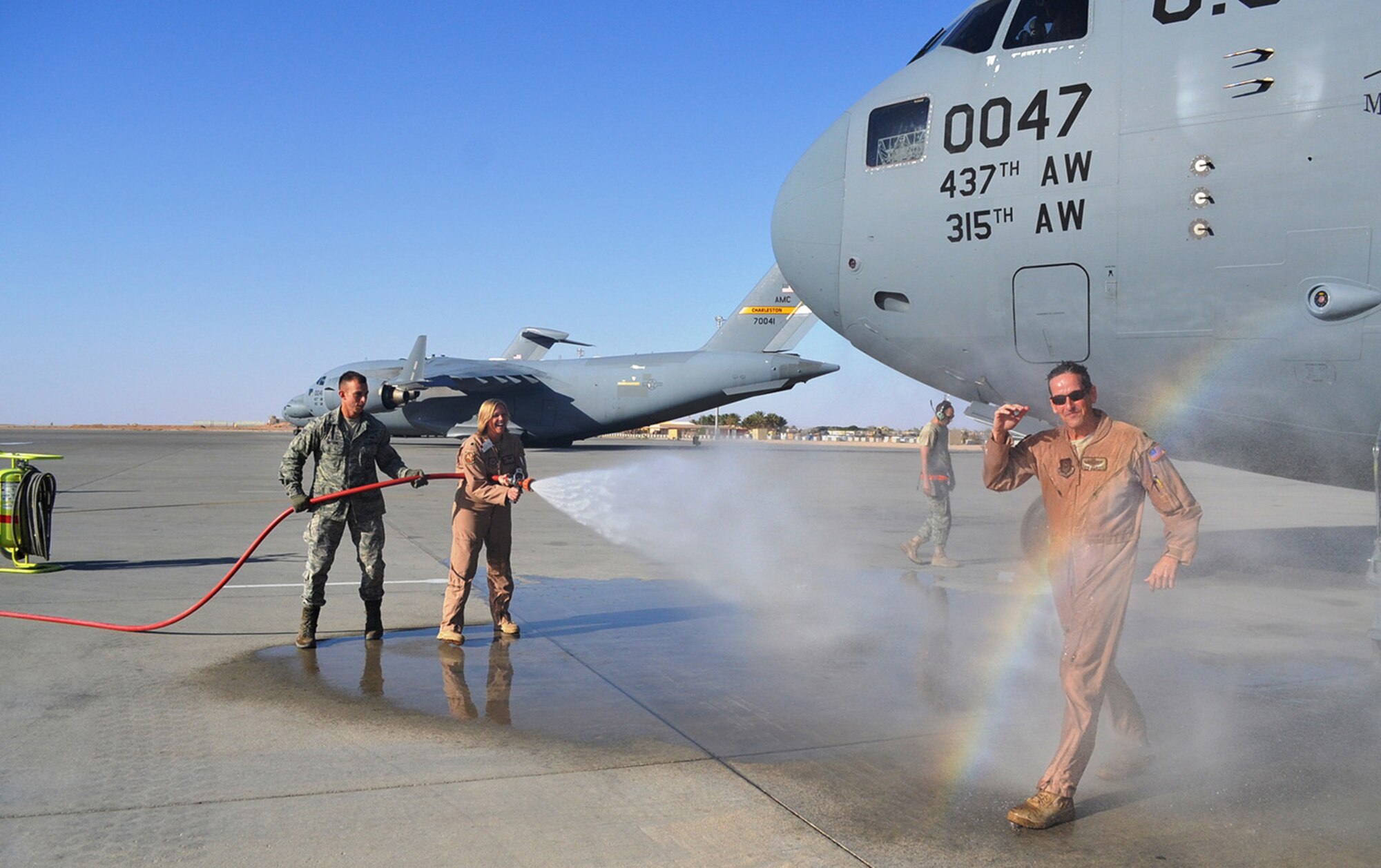 Lt. Col. Stephen Clements, a Reservist with the 313th Airlift Squadron, Joint Base Lewis-McChord, Wash., is showered with "praise" as he exits a C-17 in Southern Afghanistan.  Clements logged his 10,000th flying hour Oct. 20 while flying missions with the 405th Air Expeditionary Group in and out of Afghanistan. (U.S. Air Force photo)