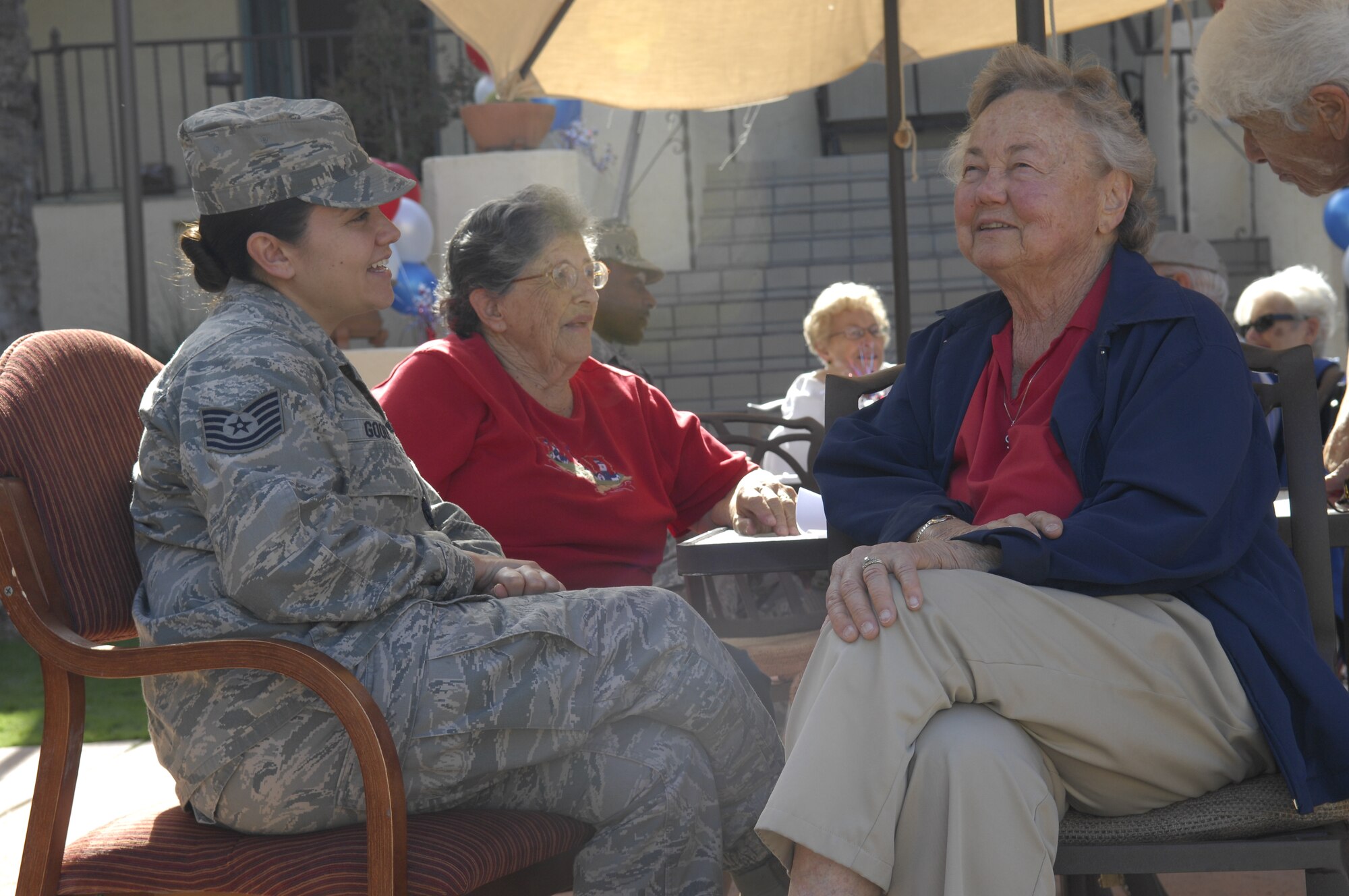 U.S. Air Force Tech. Sgt. Loraine Goody, 355th Maintenance Operation Squadron loading standardization crew member, speaks with a veteran at Atria Bell Court Gardens Retirement Community in Tucson, Ariz., Nov. 13, 2013. Fifteen Airmen from Davis-Monthan Air Force Base, Ariz., volunteered to eat lunch and hang out with the veterans to pay their respects for their service and to learn about what they went through.  (U.S. Air Force Photo by Airman 1st Class Betty R. Chevalier/Released)