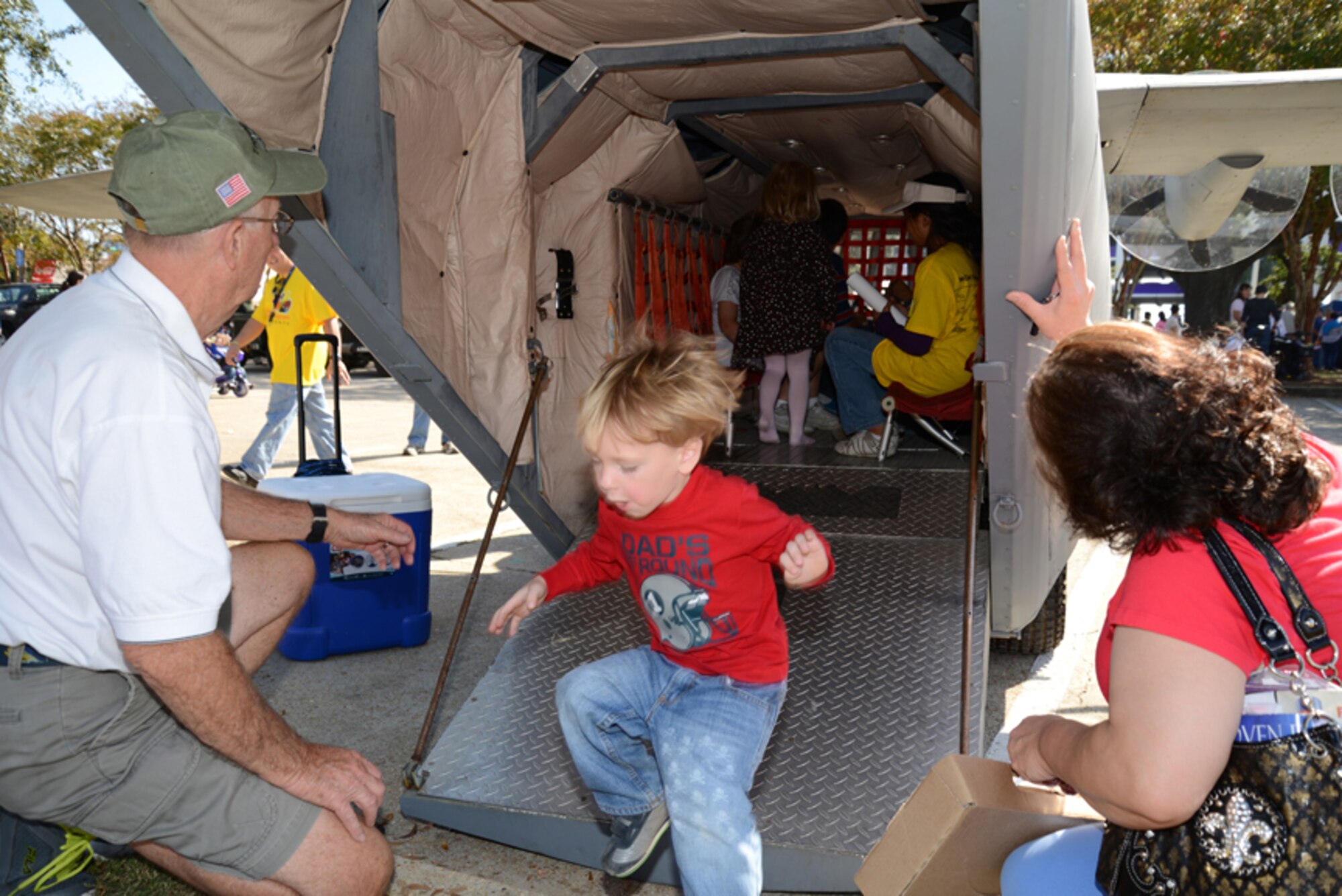 A young “paratrooper” jumps out the back of Lil' Bill, which was parked at the Biloxi Town Green after the Biloxi Veterans Day parade held Nov. 9. Members of the 403rd Wing, Keesler Air Force Base, Miss., guided the mock C-130J aircraft through the streets of Biloxi, Miss., during the event. Hundreds of people turned out to view the procession of floats, bands and marching units to show their appreciation for members of the U.S. Armed Forces. (U.S. Air Force photo/Tech. Sgt. Ryan Labadens)