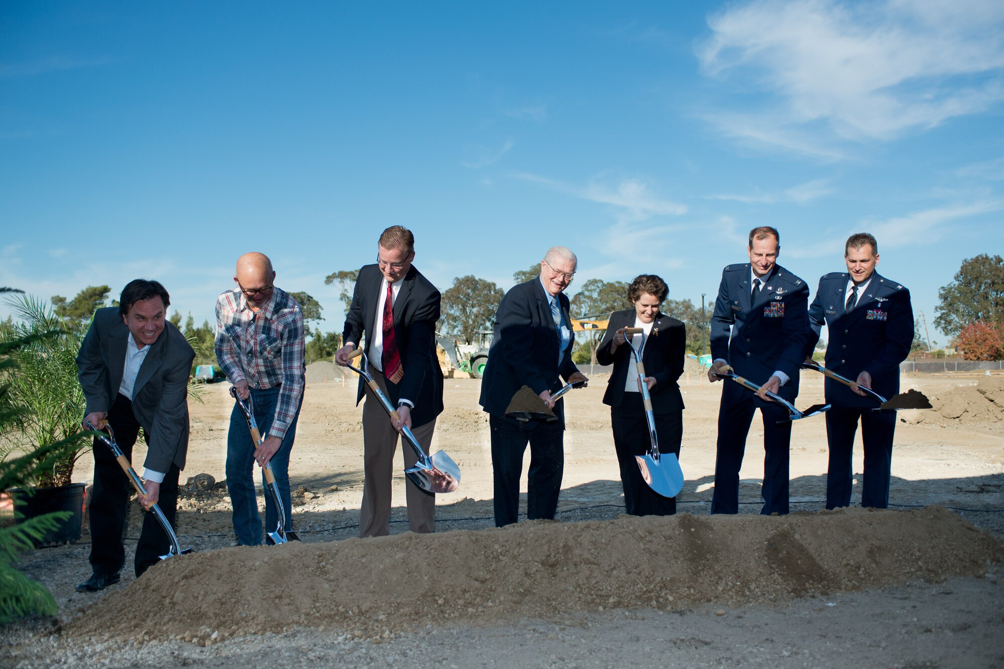 Base and civilian leaders prepare to dig the ceremonial first shovelful of dirt Wednesday at the future site of Travis Fisher House II. (U.S. Air Force photo/Ken Wright)