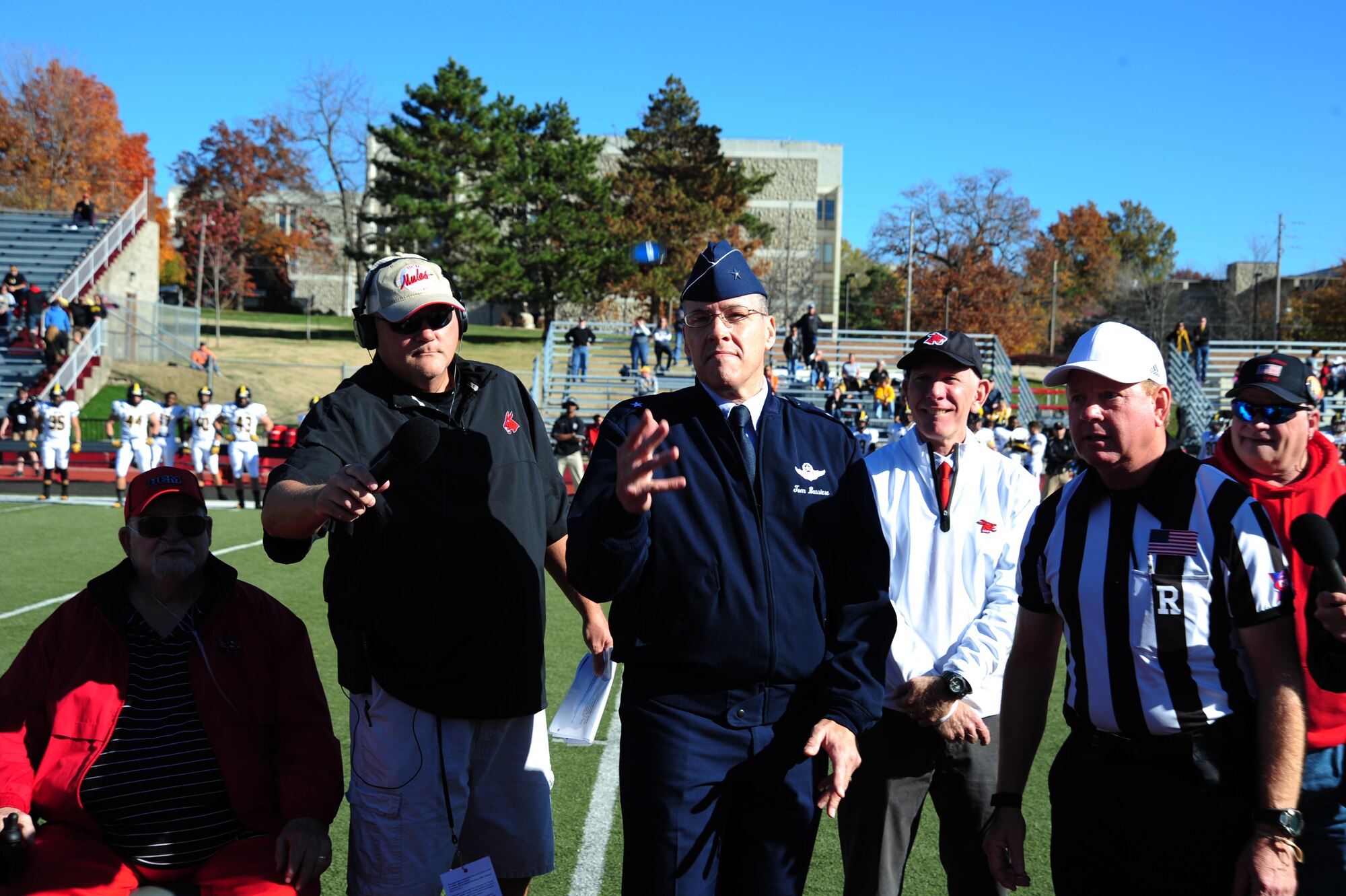 U.S. Air Force Brig. Gen. Thomas Bussiere, 509th Bomb Wing commander, flips the coin before the start of a Military Appreciation Game at the University of Central Missouri in Warrensburg, Mo., Nov. 9, 2013. Each year UCM hosts a military appreciation game to show gratitude to members of the armed forces past and present for serving their country. (U.S. Air Force photo by Staff Sgt. Nick Wilson/Released)