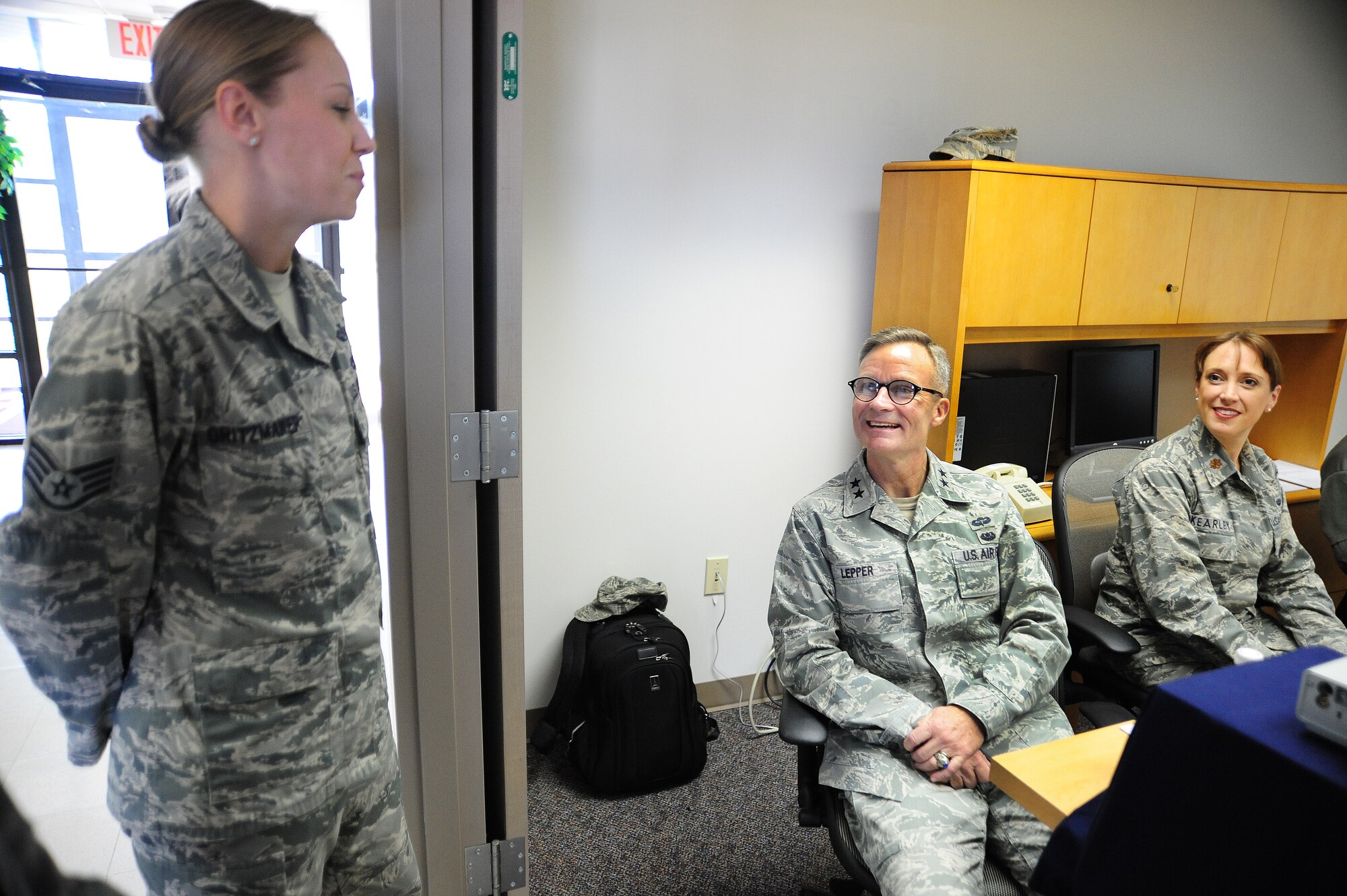 U.S. Air Force Staff Sgt. Kathryn Gritzmaker, 509th Bomb Wing Area Defense Counsel defense paralegal, shares a laugh with U.S. Air Force Maj. Gen Steven Lepper, Air Force deputy judge advocate general, and U.S. Air Force Maj. Cynthia Kearley, Air Force assistant executive officer to the judge advocate general, at Whiteman Air Force Base, Mo., Nov. 8, 2013. Lepper visited the base to tour both the legal and Area Defense Counsel offices. (U.S. Air Force photo by Staff Sgt. Nick Wilson/Released)