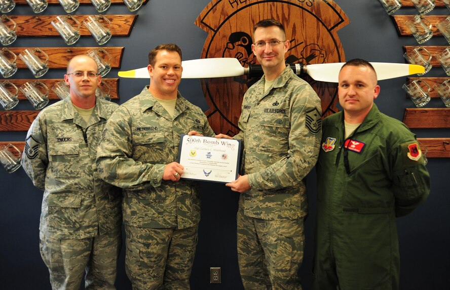 U.S. Air Force Staff Sgt. Zachary Hildebrand, 20th Reconnaissance Squadron mission intelligence coordinator, is presented with the Diamond Sharp Award by members of the First Sergeant’s Council, Nov. 11, 2013. Some of Hildebrand’s accomplishments include gathering 250 pounds of clothes and goods to donate to a local survival house and recalling self-aid and buddy care training to provide aid to a rugby teammate who suffered rapid blood loss despite having minimal supplies and no numbing agent. (U.S. Air Force photo by Staff Sgt. Nick Wilson/Released)