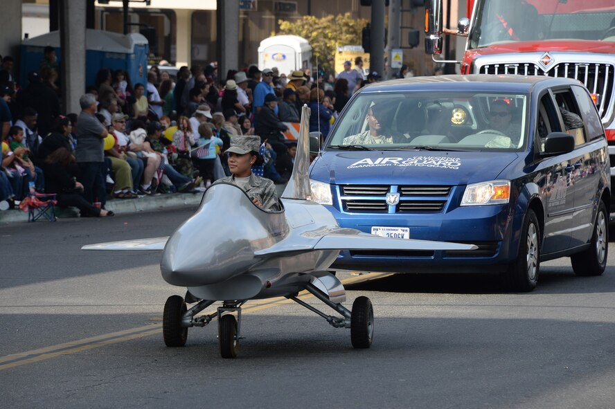 U.S. Air Force Senior Airman Karen Jones, 144th Fighter Wing recruiter, pilots the motorized F-16 through the streets of downtown Fresno, Calif. during the annual Veteran’s Day Parade Nov. 11, 2013. The parade is the largest of its type west of the Mississippi. (Air National Guard photo by Senior master Sgt. Chris Drudge)