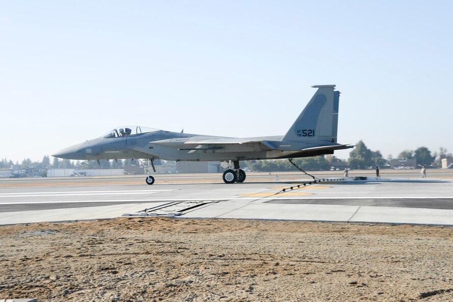 A California Air National Guard F-15 Eagle assigned to the 144th Fighter Wing catches the aircraft arresting cable of the Barrier Arresting Kit 12/14 with its tail hook during the certification engagement exercise held at the Fresno Yosemite International Airport Nov. 2, 2013. (Air National Guard photograph by Tech. Sgt. Vaughn)