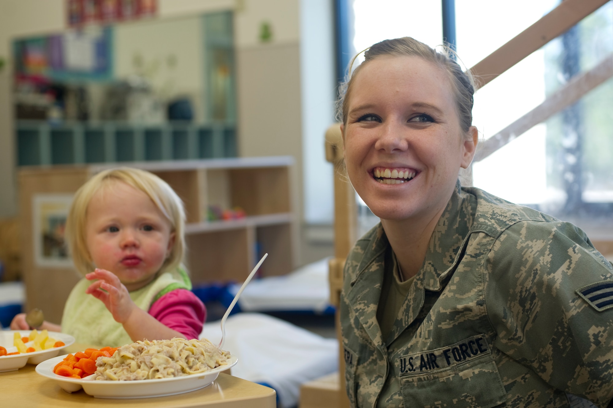 Senior Airman Skye Escalera, 1st Special Operations Medical Group patient travel coordinator, eats lunch with her daughter at a child development center on Hurlburt Field, Fla., Nov. 14, 2013. Parents can meet their children for a free lunch at the base CDCs any day during the work week. (U.S Air Force photo/Senior Airman Naomi Griego)      
