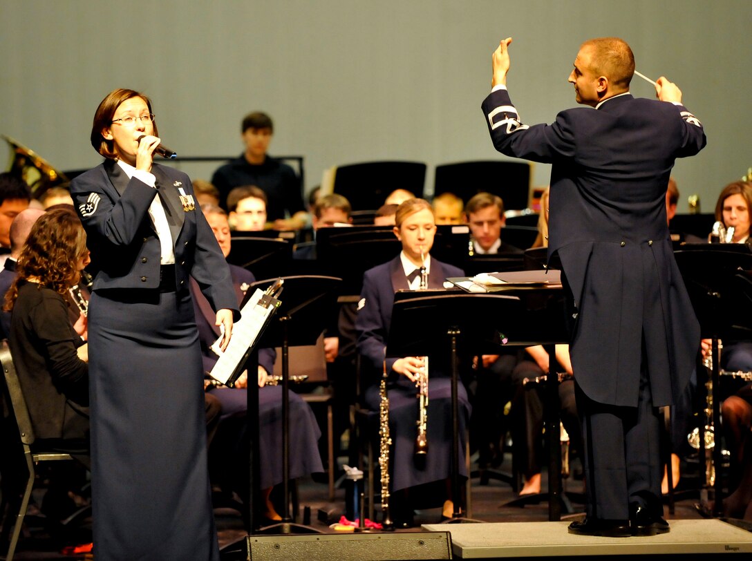 U.S. Air Force Staff Sgt. Rachel Webber, U.S. Air Force Heritage of America Band vocalist, sings Larry Grossman’s “The Last Full Measure of Devotion,” during the “Side by Side” concert at Warhill High School in Williamsburg, Va., Nov. 14, 2013. The concert featured more than 90 musicians from the USAF Heritage of America Band and the College of William and Mary Wind Ensemble. (U.S. Air Force photo by Staff Sgt. Wesley Farnsworth/ Released)

