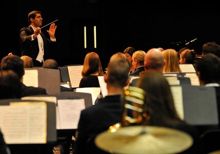 Paul Bhasin, William and Mary College director of bands and assistant professor of music, leads a band of more than 90 musicians during a “Side by Side” concert with the U.S. Air Force Heritage of America Band at Warhill High School in Williamsburg, Va., Nov. 14, 2013. The concert, which drew a crowd of more than 400 people, featured musical pieces by Aaron Copland, Leonard Bernstein and John Philip Sousa, as well as a musical salute to military veterans.  (U.S. Air Force photo by Staff Sgt. Wesley Farnsworth/ Released)