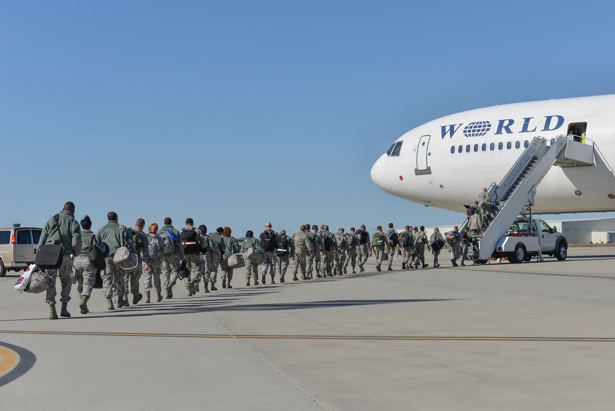 U.S. Air Force Airmen from the 117th Air Control Squadron, Georgia Air National Guard board a plane, Nov. 13, 2013 at the Savannah Combat Readiness Training Center in Garden City, Ga. About 110 members of 117ACS have deployed for six months to Southwest Asia in support of Operation Enduring Freedom. (U.S. Air National Guard photo by Master Sgt. Charles Delano/released)