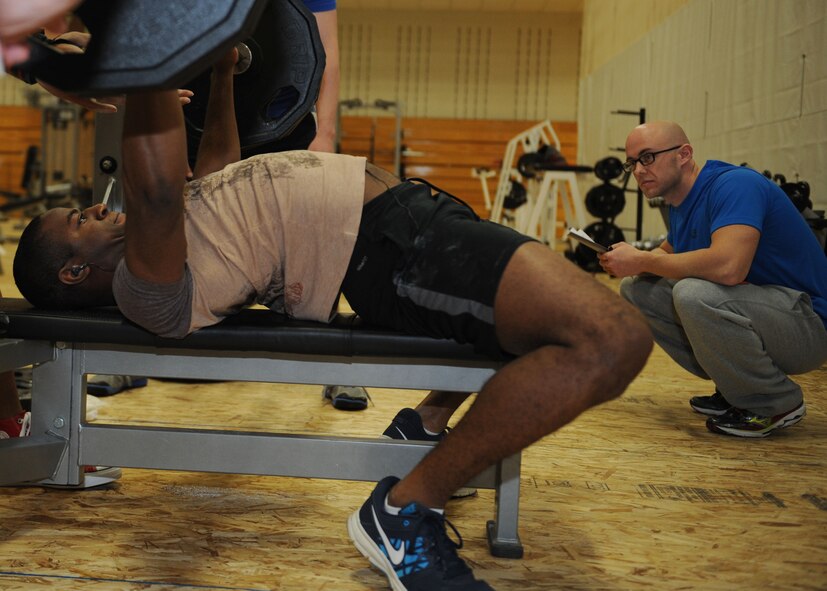 Airman 1st Class Shaquille Robinson, 432nd Attack Squadron mission intelligence coordinator, performs a bench press during a powerlifting competition in the Bellamy Fitness Center at Ellsworth Air Force Base, S.D., Nov. 13, 2013.  To avoid damage to muscles and other areas of the body, participants were given 15 minutes to warm up before the competition began. (U.S. Air Force photo by Airman 1st Class Rebecca Imwalle / Released)