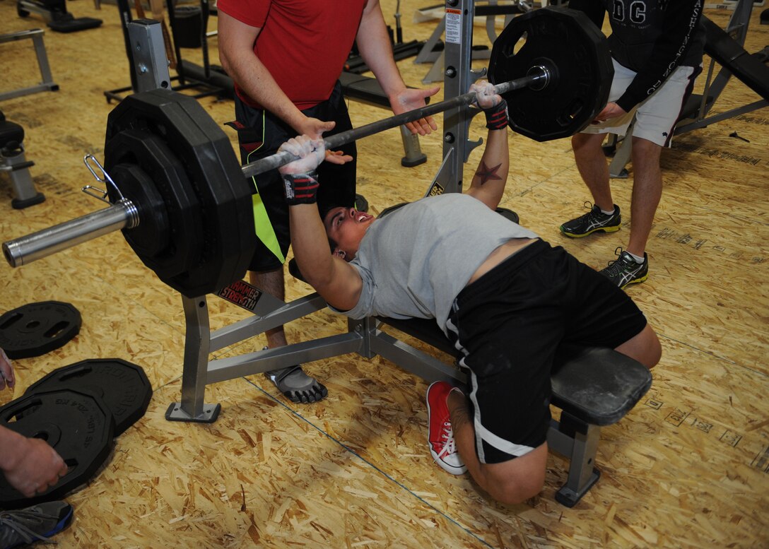 Senior Airman Josiah Tirado-Bailey, 28th Operations Support Squadron target analyst, performs a bench press during a powerlifting competition in the Bellamy Fitness Center at Ellsworth Air Force Base, S.D. Nov. 13, 2013. During the competition, contestants were judged on a ratio of amount lifted to body weight. (U.S. Air Force photo by Airman 1st Class Rebecca Imwalle / Released)