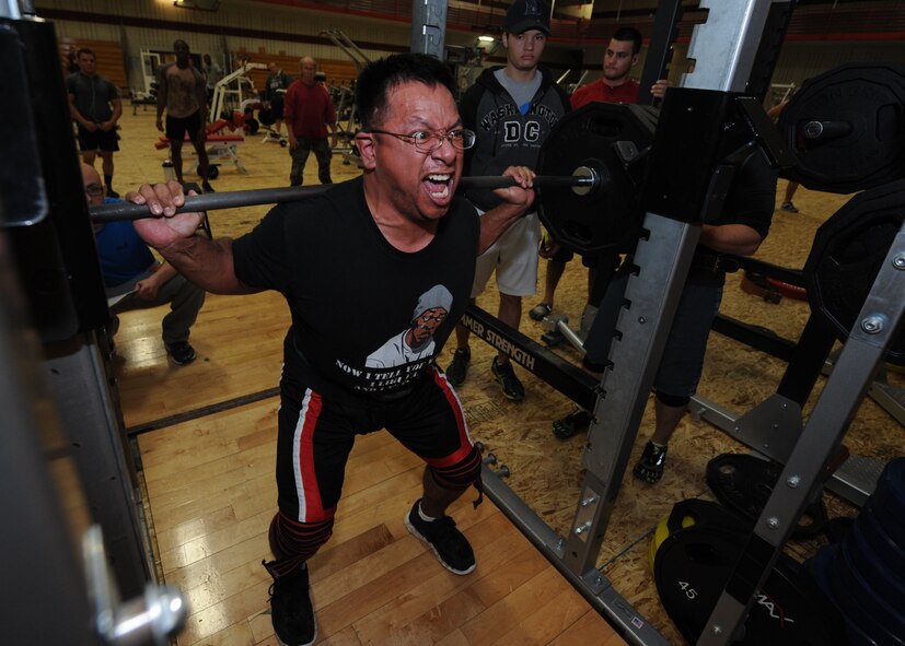 Tech. Sgt. Jaime Torres, 28th Medical Support Squadron NCO in charge of medical maintenance, performs a squat lift during a powerlifting competition in the Bellamy Fitness Center at Ellsworth Air Force Base, S.D., Nov. 13, 2013. The strength competition was open to all Ellsworth personnel and their families, and required participants to complete a one-repetition maximum in a bench press, squat and dead lift. (U.S. Air Force photo by Airman 1st Class Rebecca Imwalle / Released)