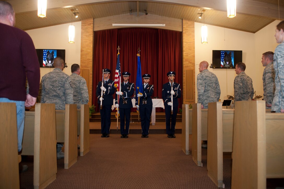 Members of the Ellsworth Honor Guard post the colors in a memorial service conducted in the Freedom Chapel at Ellsworth Air Force Base, S.D., Nov. 12, 2013. The event was held to honor a 28th Security Forces Squadron military working dog named Arco who served in the Air Force for more than three years as a narcotics and patrol K-9. (U.S. Air Force photo by Senior Airman Zachary Hada/Released)