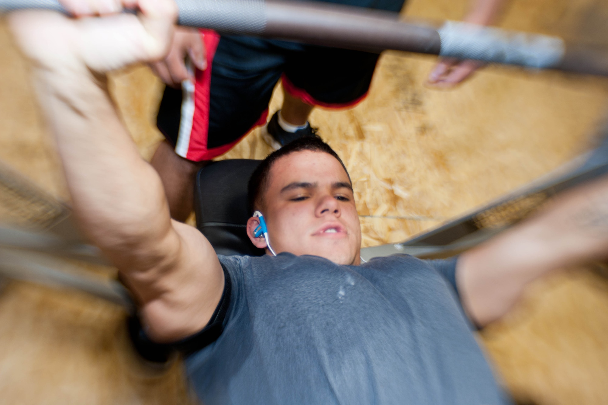 Senior Airman Brandon Stout, 28th Civil Engineer Squadron Fire Department driver operator, performs a bench press during a powerlifting competition in the Bellamy Fitness Center at Ellsworth Air Force Base, S.D., Nov. 13, 2013. All of the contestants were given three chances to lift their maximum weight in the three different lifts — squat, dead lift and bench press. (U.S. Air Force photo by Senior Airman Zachary Hada/Released)