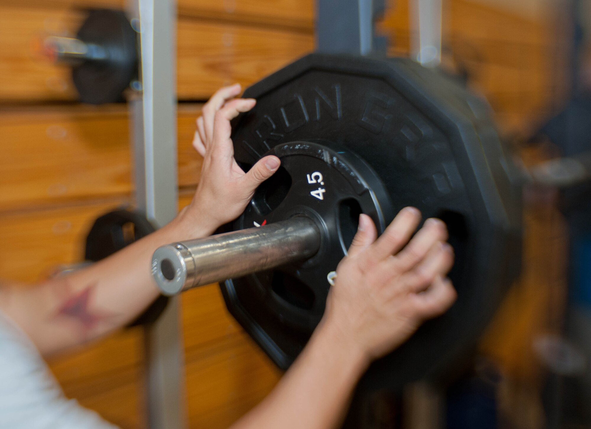 Senior Airman Josiah Tirado-Bailey, 28th Operation Support Squadron target analyst, racks weights during a powerlifting competition in the Bellamy Fitness Center at Ellsworth Air Force Base, S.D., Nov. 13, 2013. During the competition, contestants were judged on a ratio of amount lifted to body weight. (U.S. Air Force photo by Senior Airman Zachary Hada/Released)